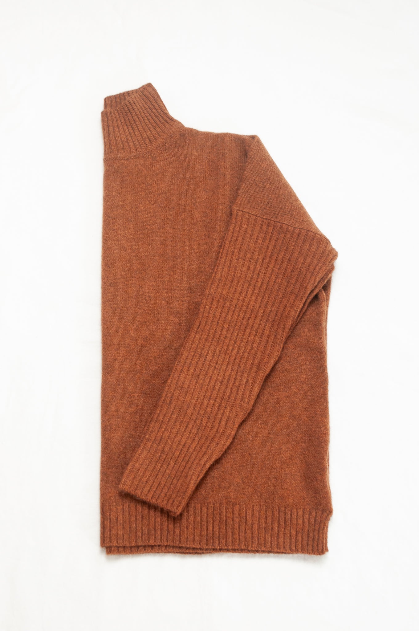 Baby yak wool Maxim one size turtle neck sweater with rib sleeves in rust brown.
