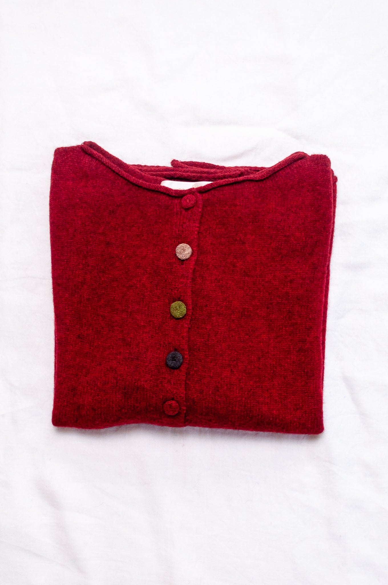 Baby yak one size reversible cardigan sweater with hand embroidered buttons in cherry red.