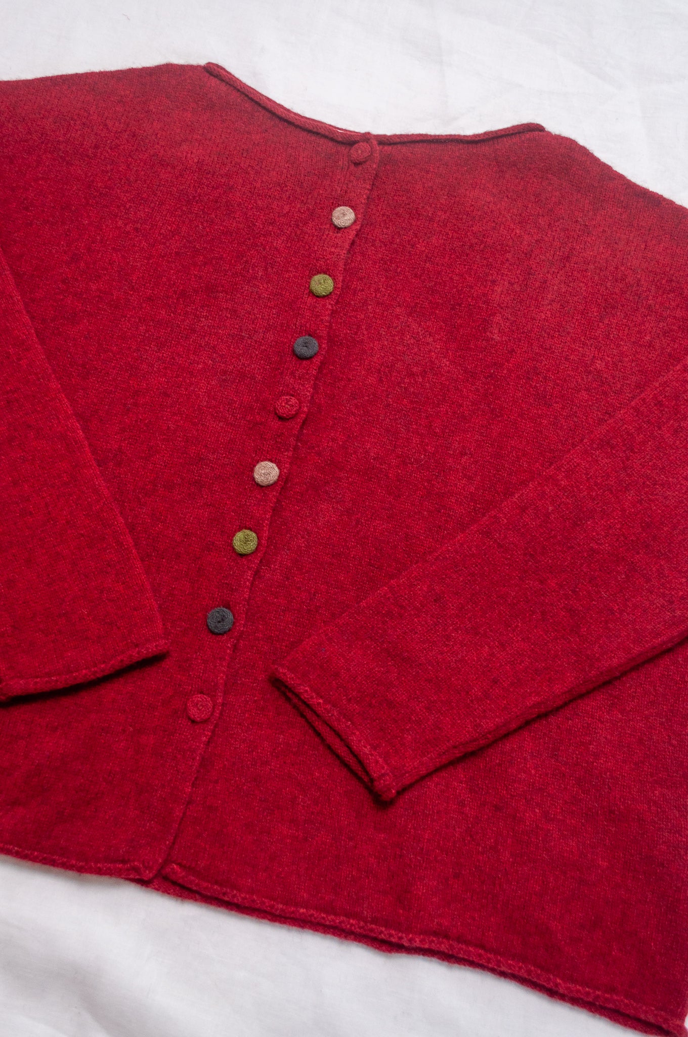 Baby yak one size reversible cardigan sweater with hand embroidered buttons in cherry red.