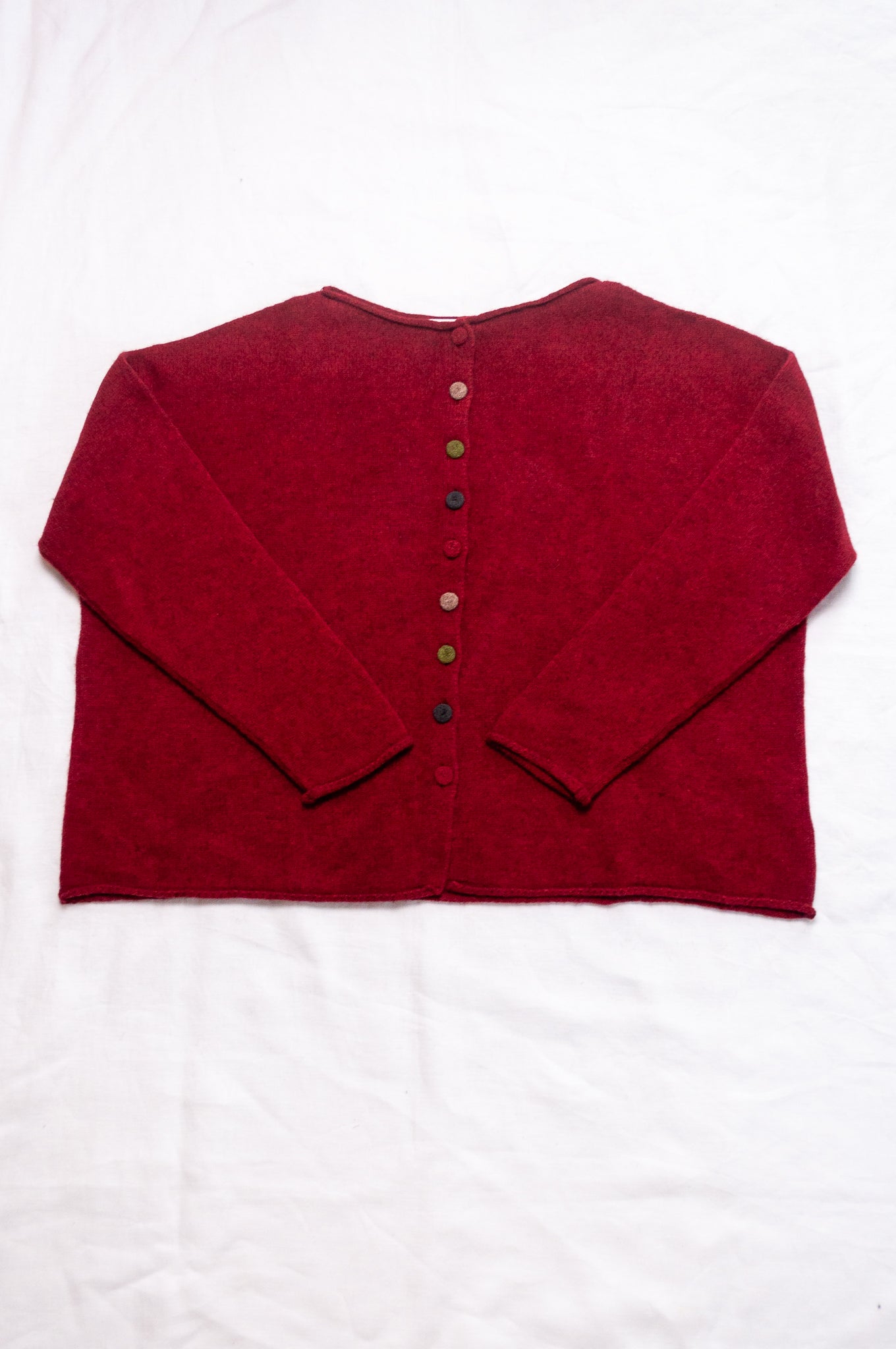 Baby yak one size reversible cardigan sweater with hand embroidered buttons in cherry red.