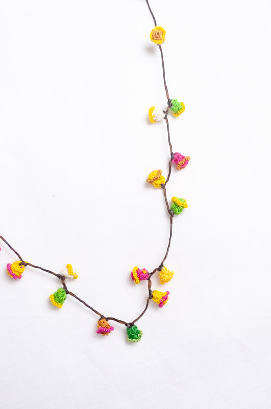 Handmade Moroccan button necklace in bright lemon yellow, rose pink and leaf green.