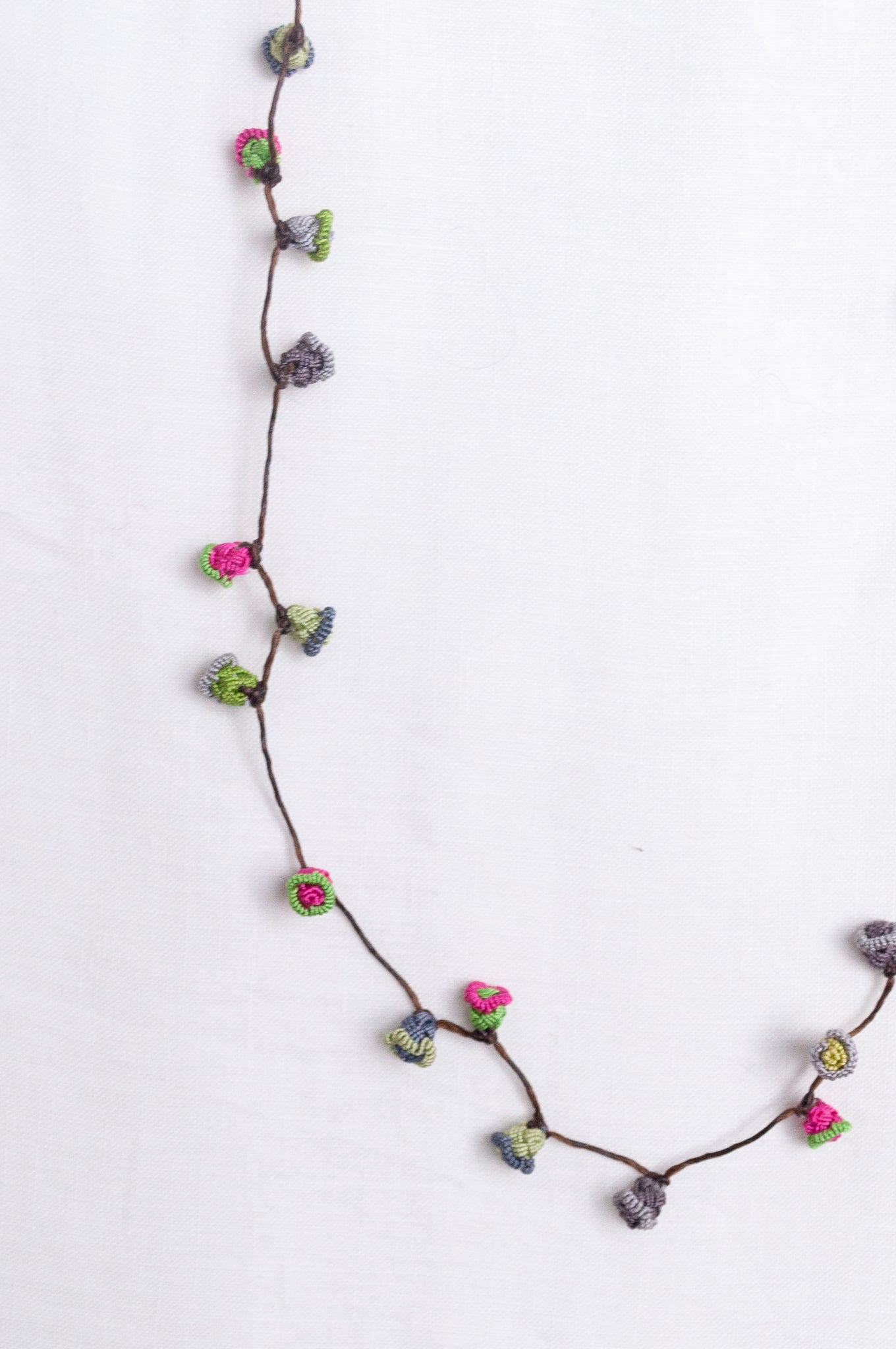 Handmade Moroccan button necklace in rose pink and sage greens.