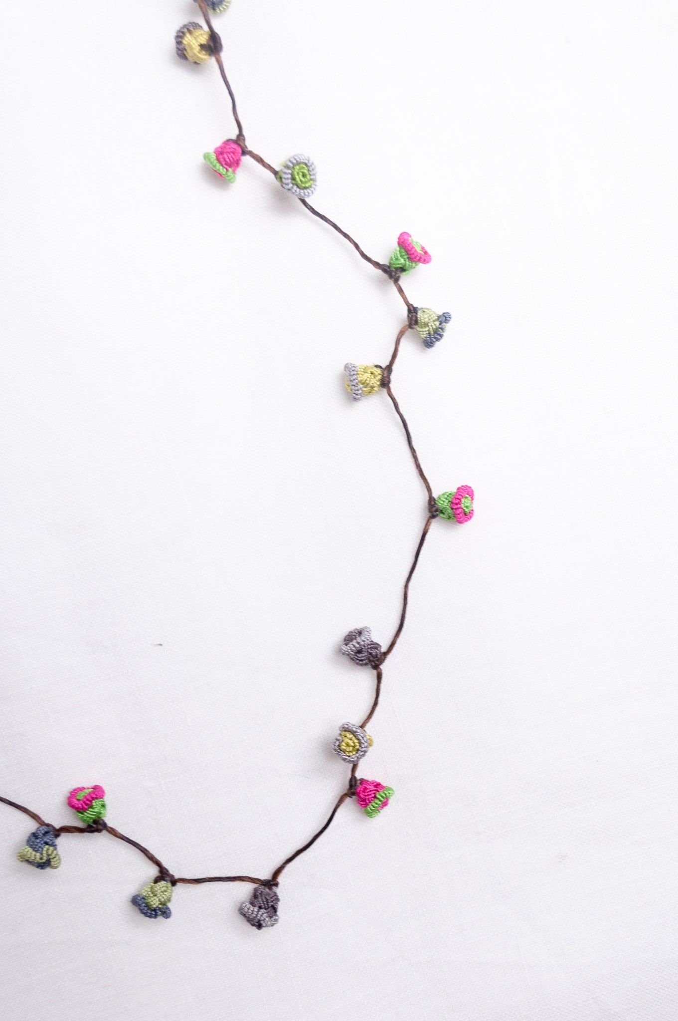 Handmade Moroccan button necklace in rose pink and sage greens.