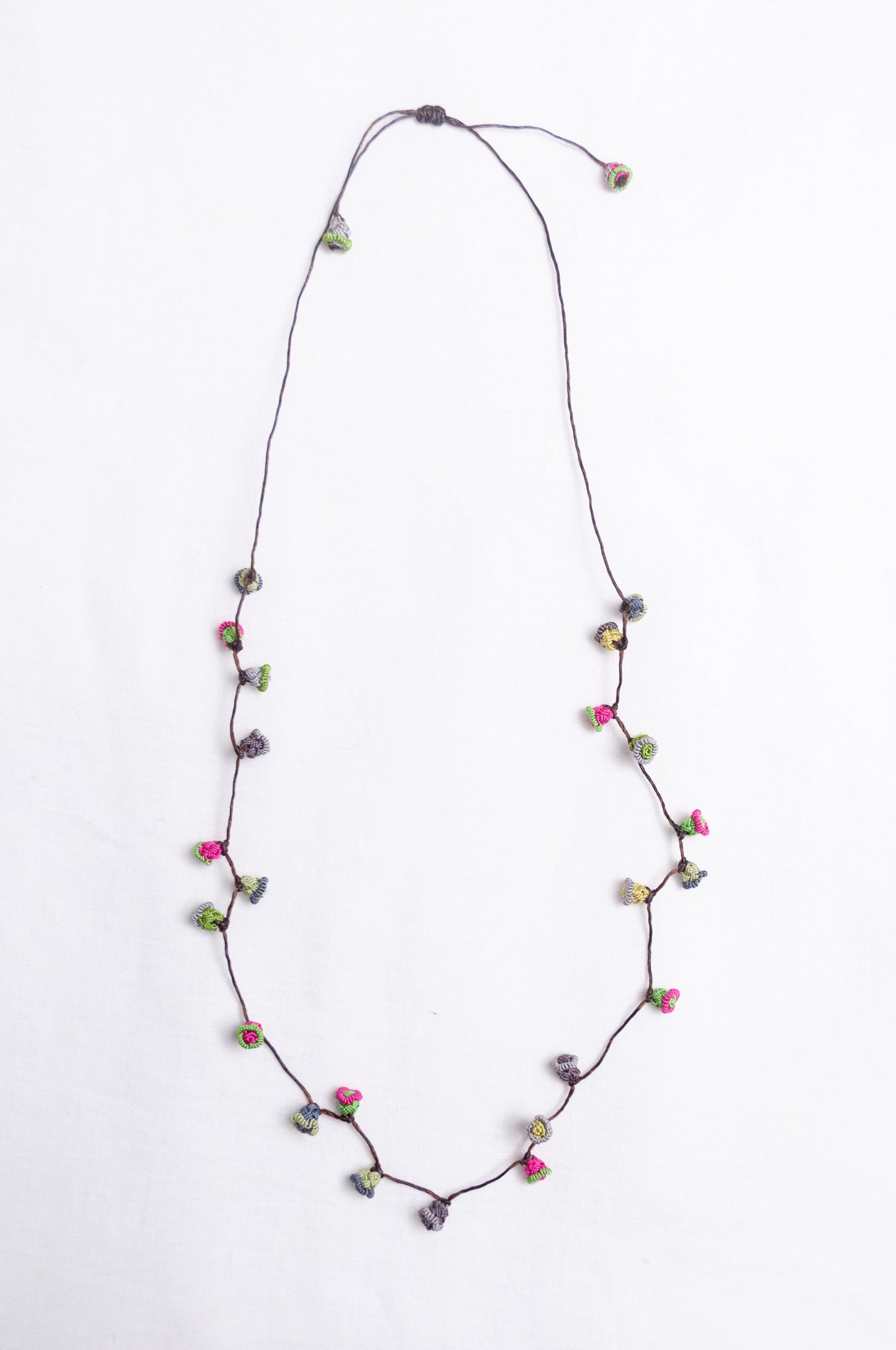 Handmade Moroccan button necklace in rose pink and sage greens.