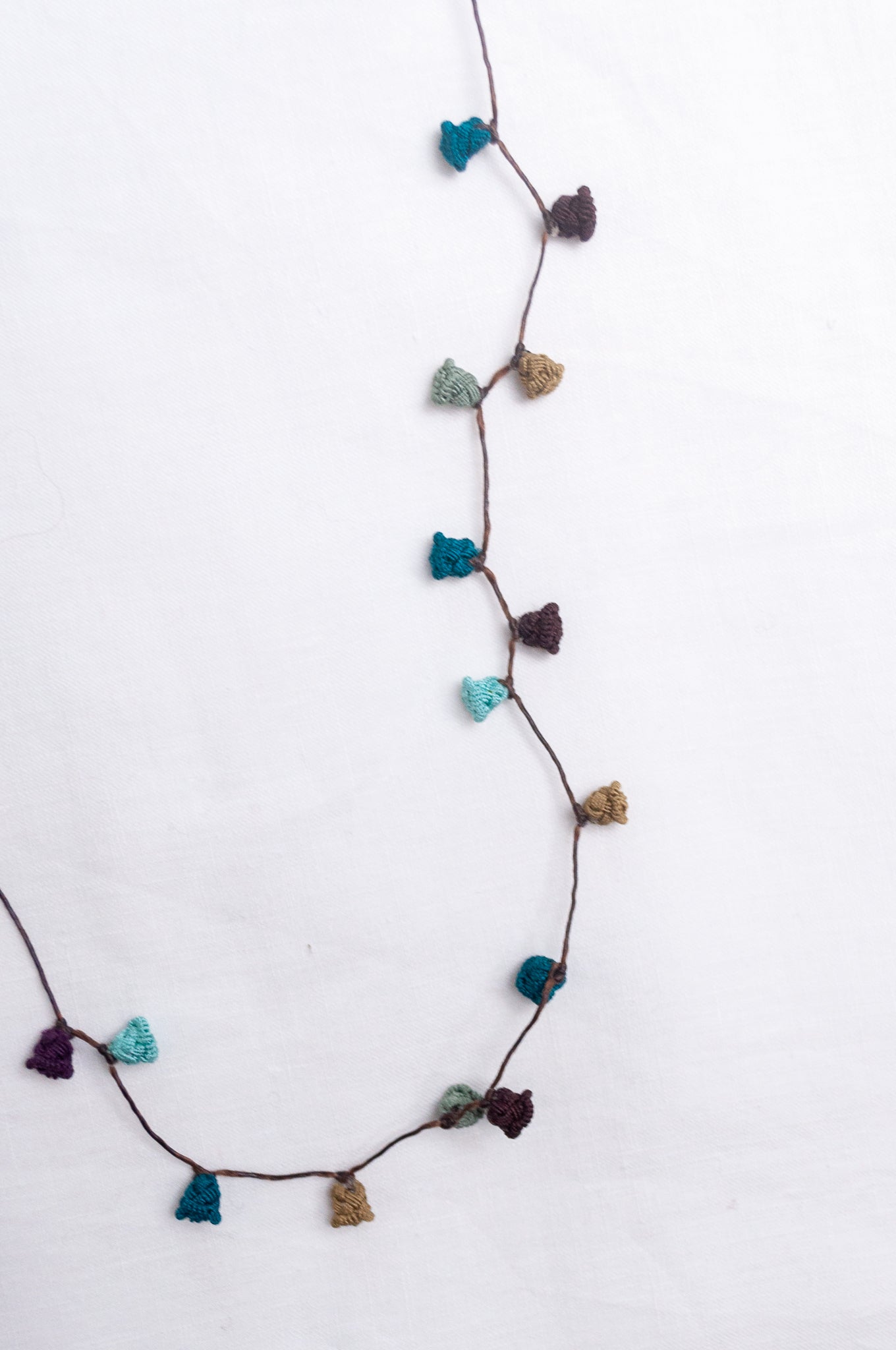 Handmade Moroccan button necklace in shades of green and brown.