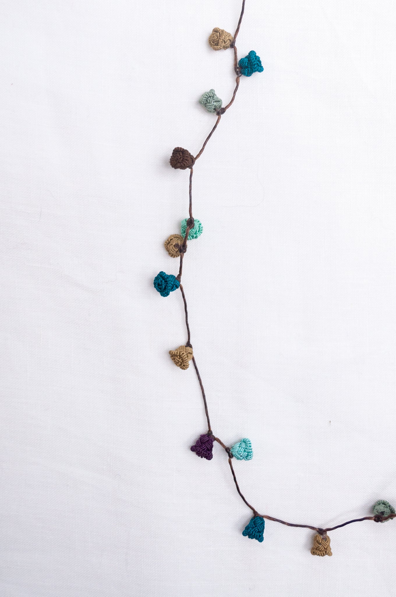 Handmade Moroccan button necklace in shades of green and brown.