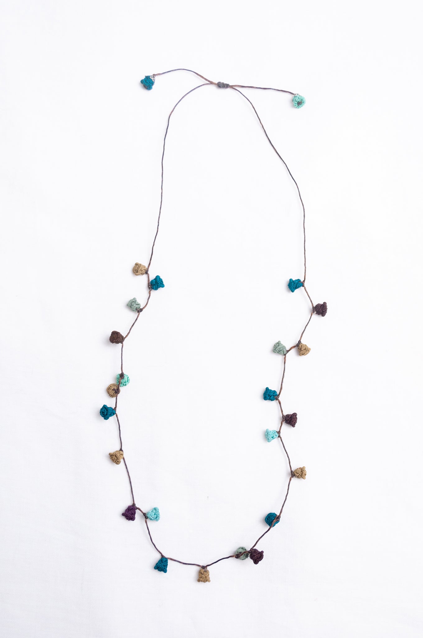 Handmade Moroccan button necklace in shades of green and brown.