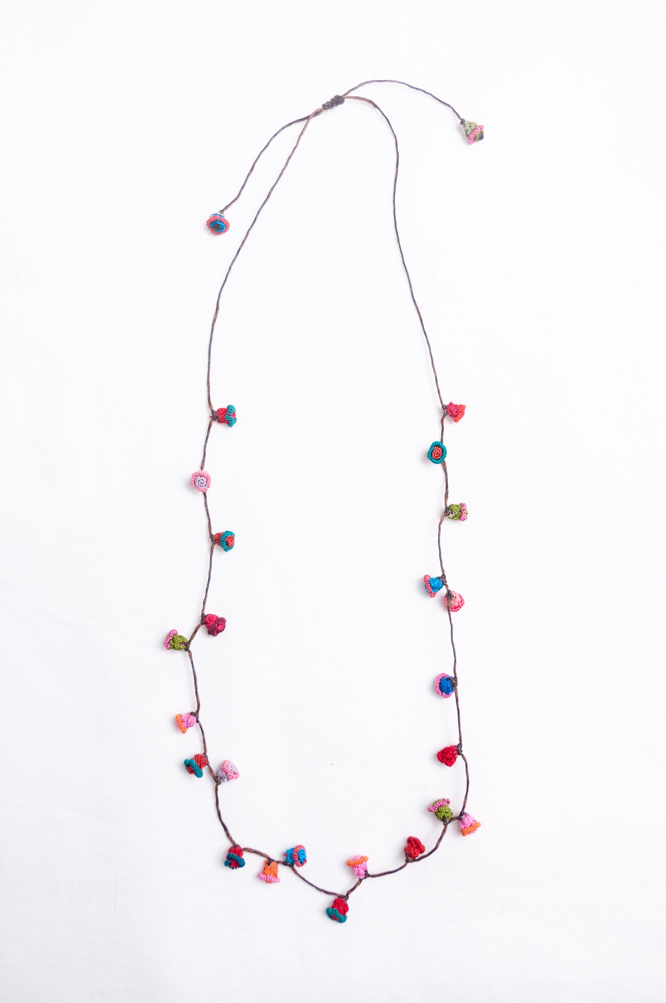 Handmade Moroccan button necklace in turquoise, pink and red.