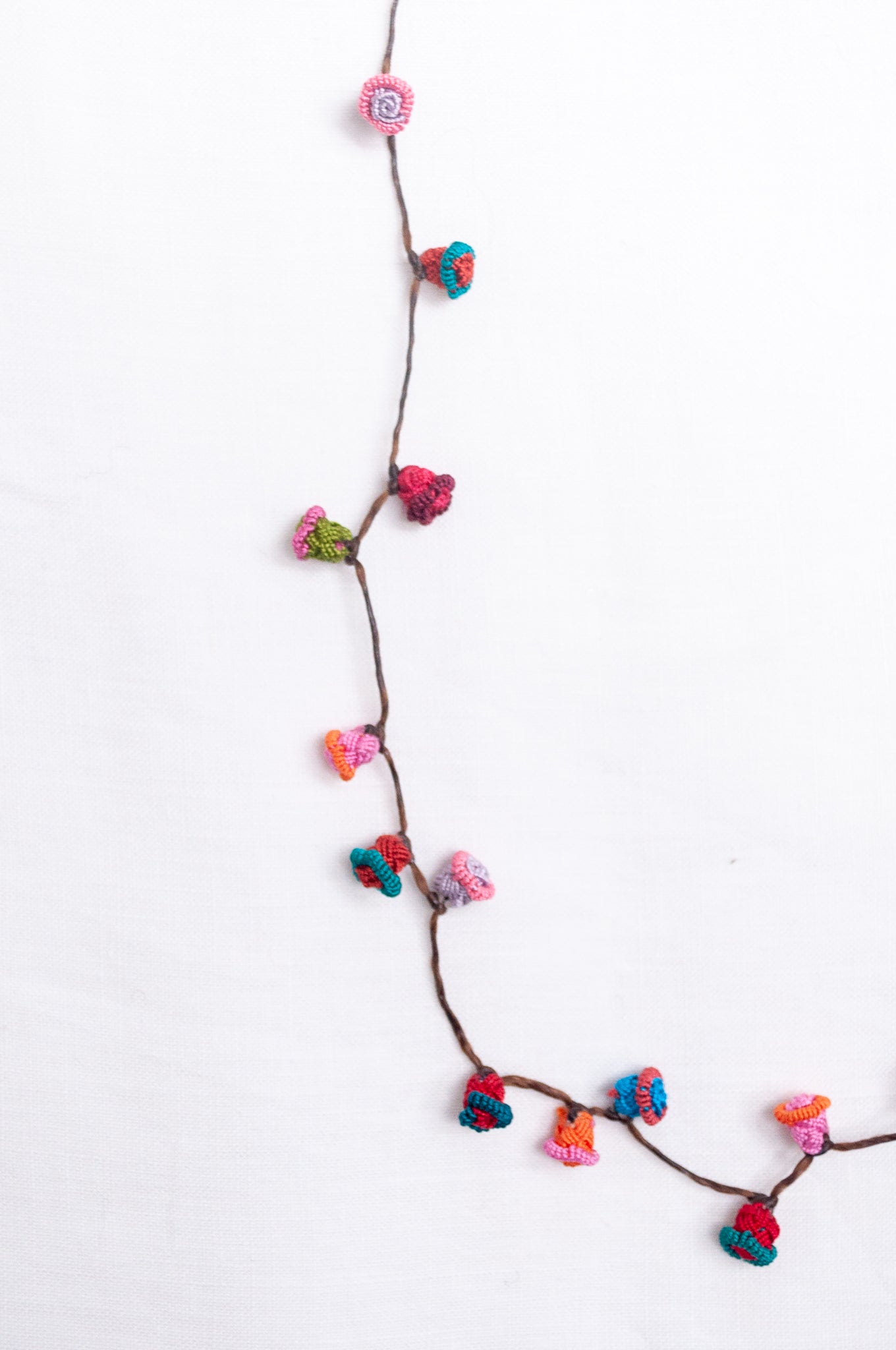 Handmade Moroccan button necklace in turquoise, pink and red.