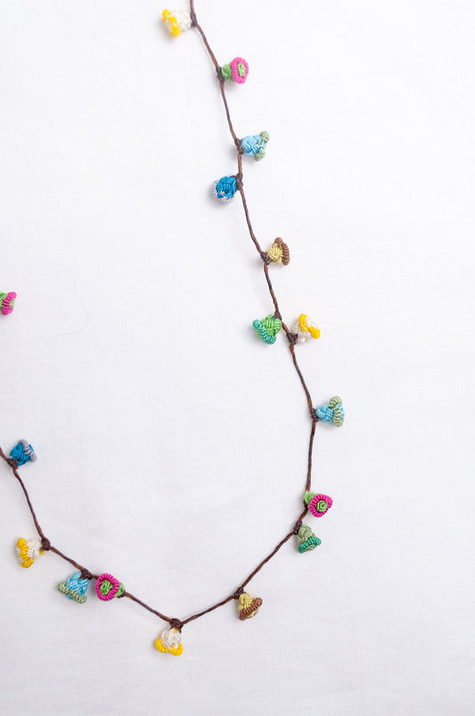 Handmade Moroccan button necklace in  soft pastels.