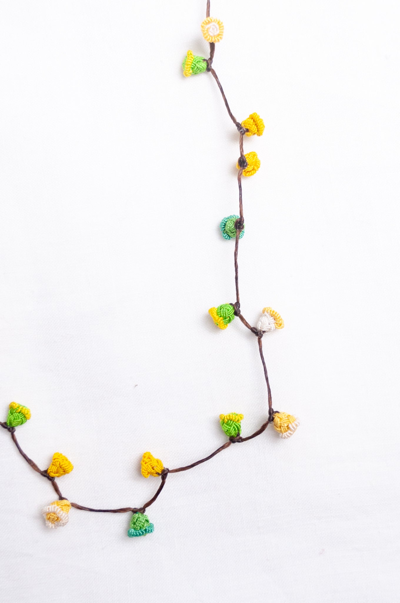 Handmade Moroccan button necklace in lemon yellow and lime green.