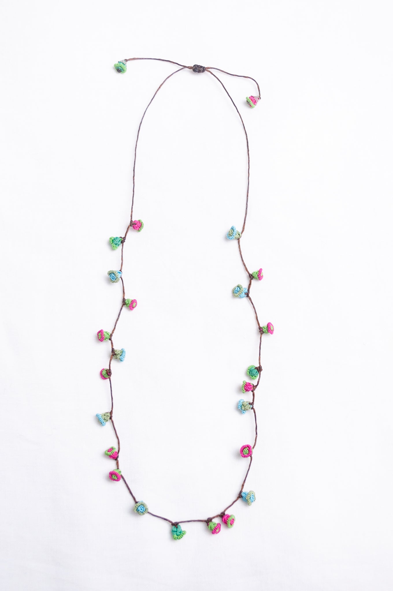 Handmade Moroccan button necklace in blue, pink and soft green.