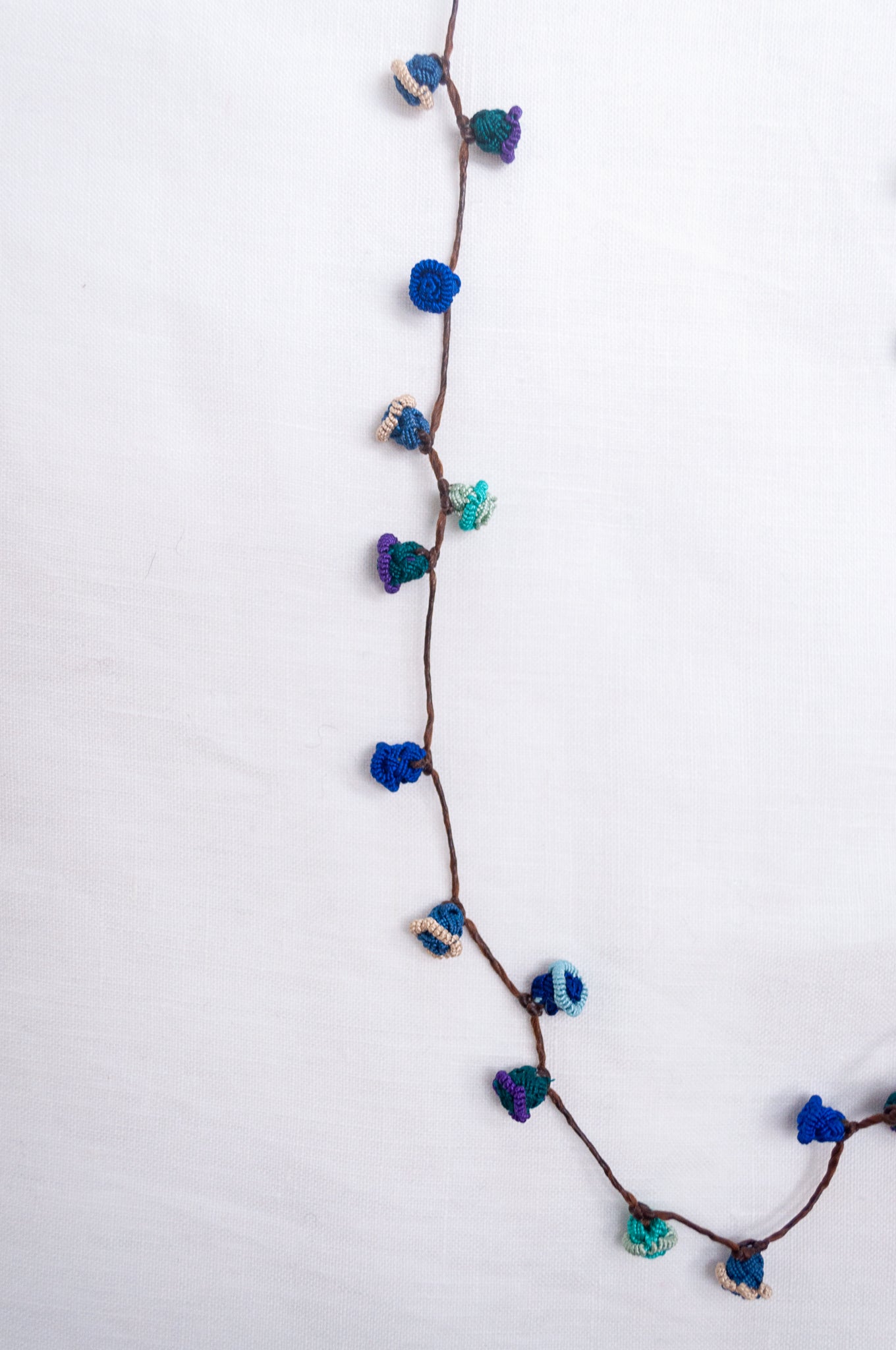 Handmade Moroccan button necklace in ocean blues and greens.