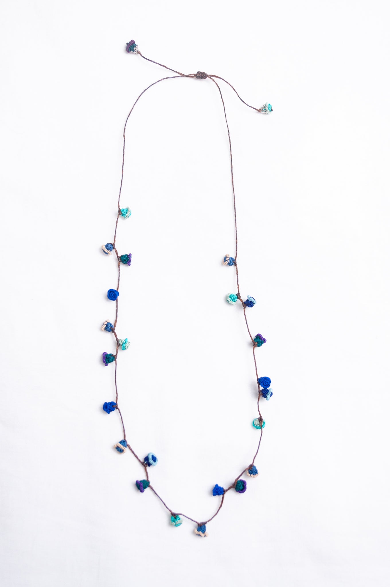 Handmade Moroccan button necklace in ocean blues and greens.