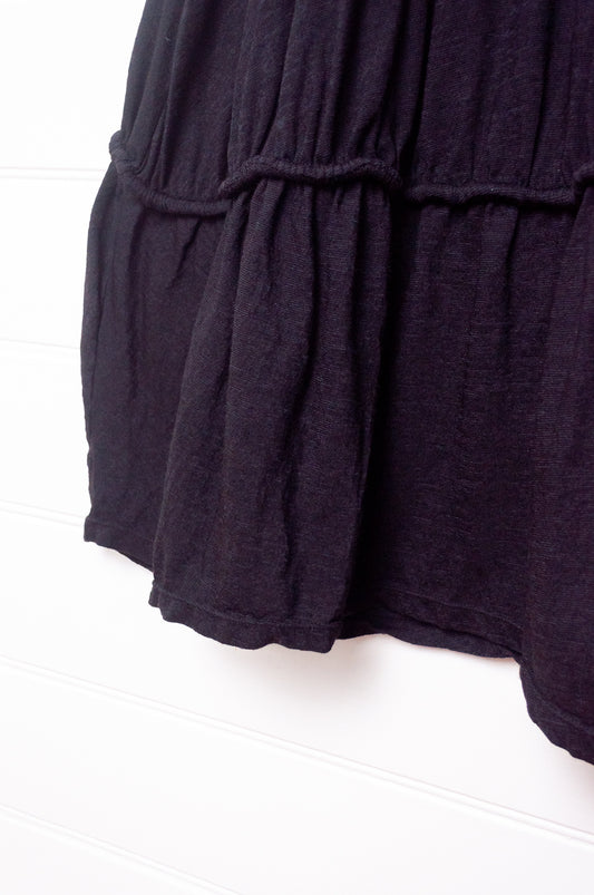 Valia Dreamscape merino wool jersey gathered skirt with frill at hem in black.