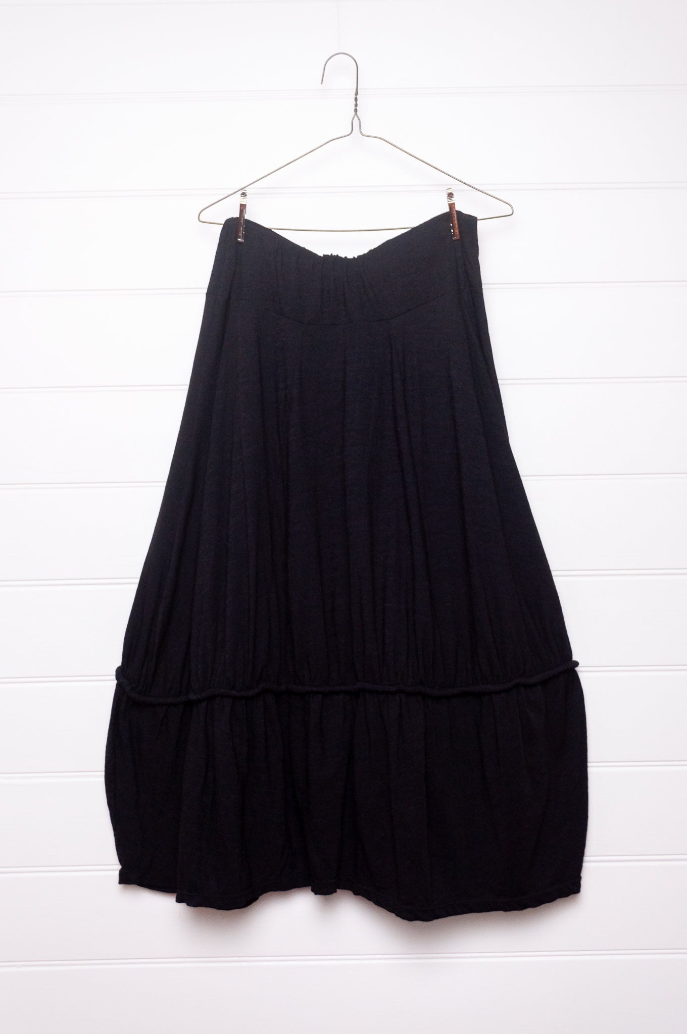 Valia Dreamscape merino wool jersey gathered skirt with frill at hem in black.