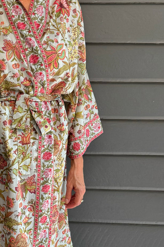 Juniper Hearth cotton voile kimono in tropical sky print, pink and lime green flowers on celadon blue background.