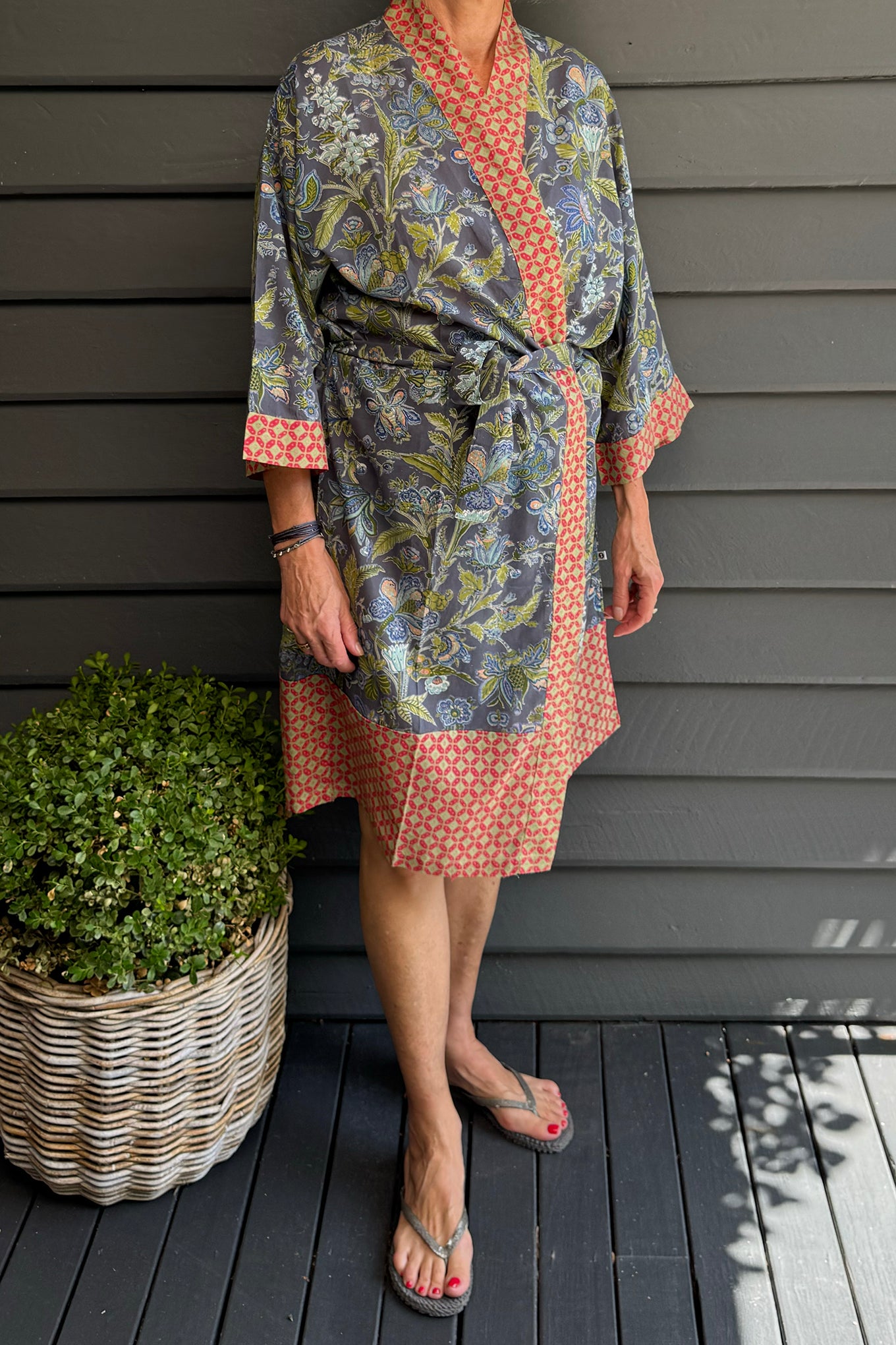 Juniper Hearth cotton voile kimono in tropical storm print, blue and olive green flowers on grey blue background.