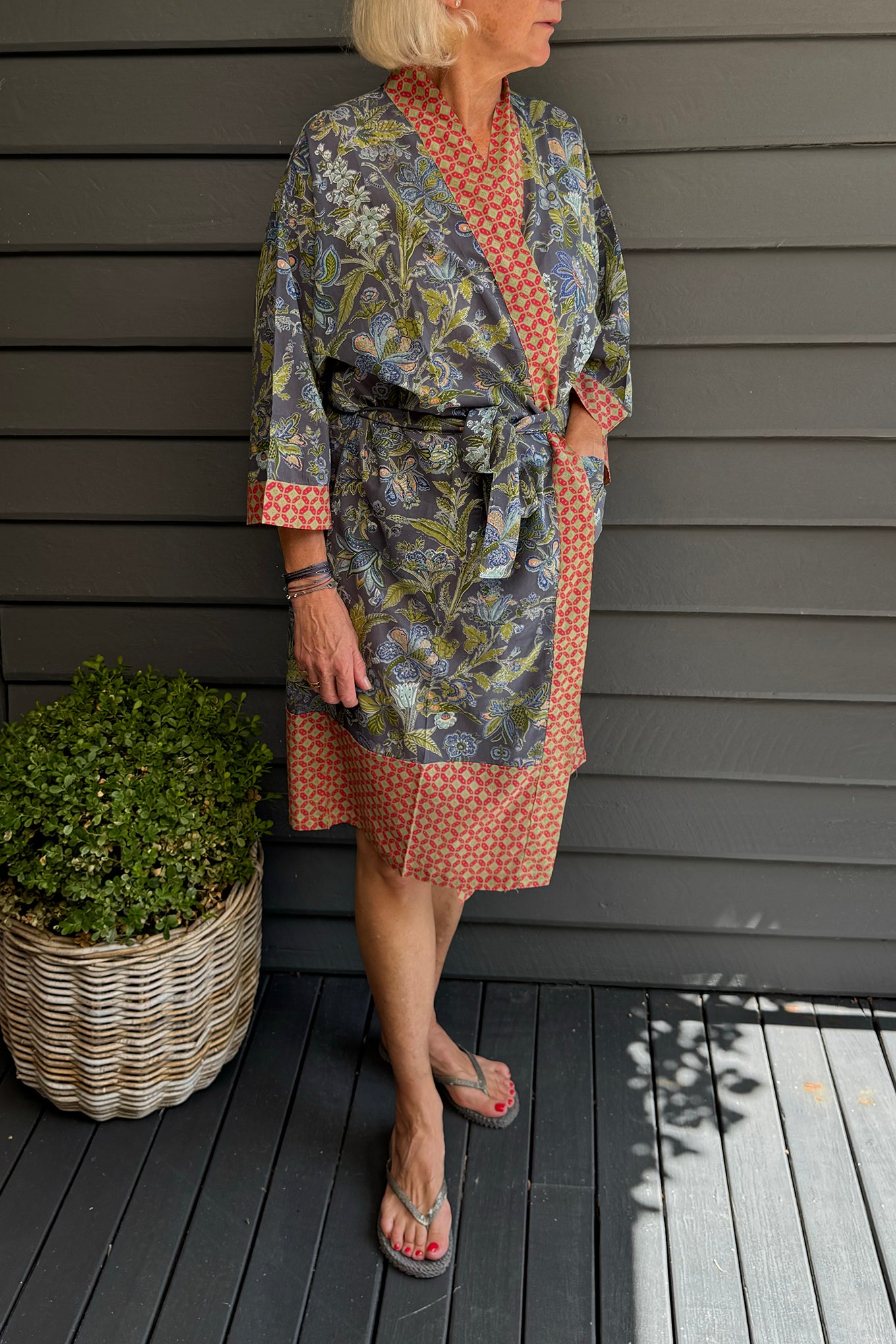 Juniper Hearth cotton voile kimono in tropical storm print, blue and olive green flowers on grey blue background.