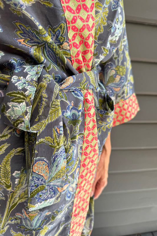 Juniper Hearth cotton voile kimono in tropical storm print, blue and olive green flowers on grey blue background.