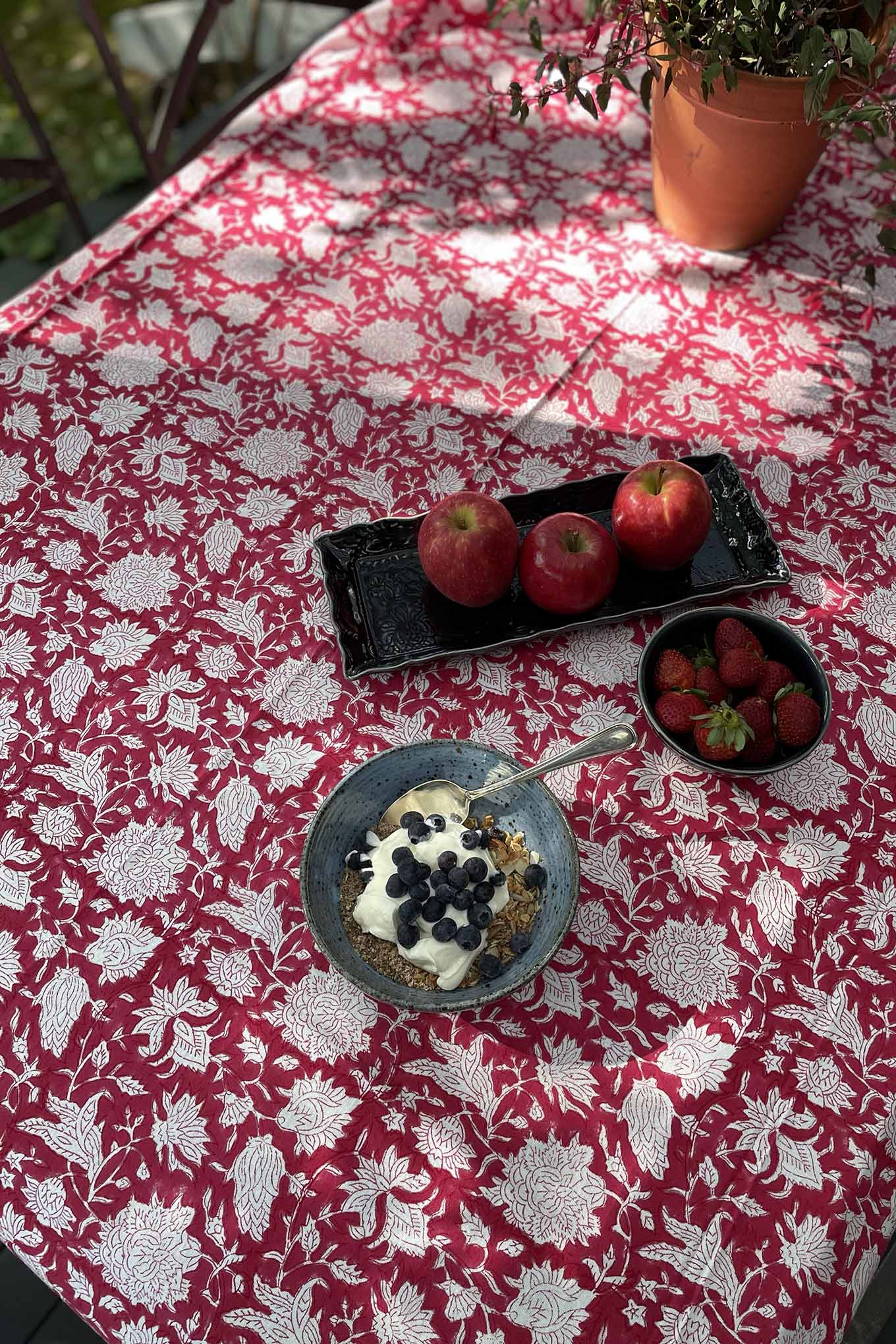 Blockprinted cotton table cloth in raspberry red and white floral design, made by hand