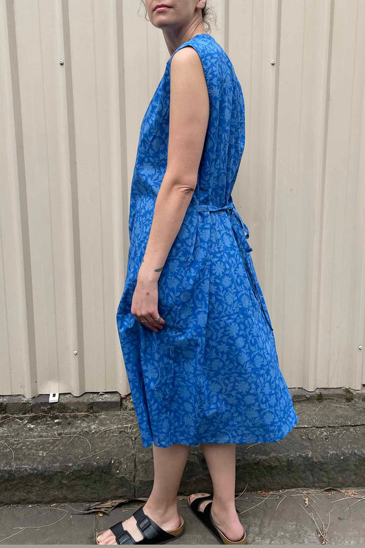 Juniper hearth Zoe dress button up sleeveless with waist ties, made from cotton cornflower blue blockprint floral.