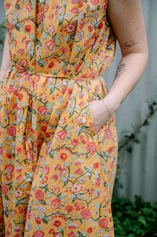 Juniper Hearth Zoe blockprint floral sleeveless cotton dress, buttonup with waist tie, in mustard yellow.