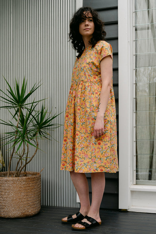 Juniper Hearth blockprint cotton dress with gathered skirt and pockets, in mustard floral.