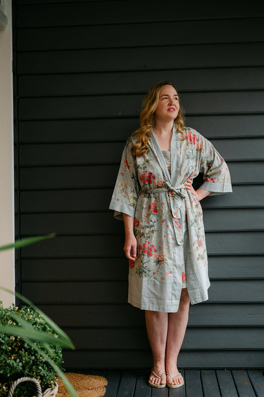Juniper Hearth cotton voile kimono in country garden print, pink and vanilla flowers on duck egg blue background.
