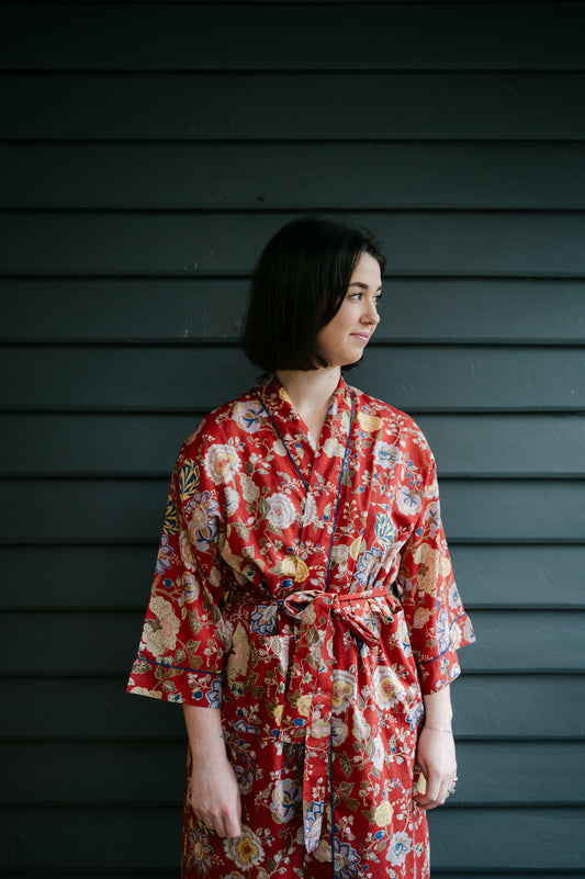 Juniper Hearth kimono in Malabar rust gold and cream and denim blue flowers on rust red background.