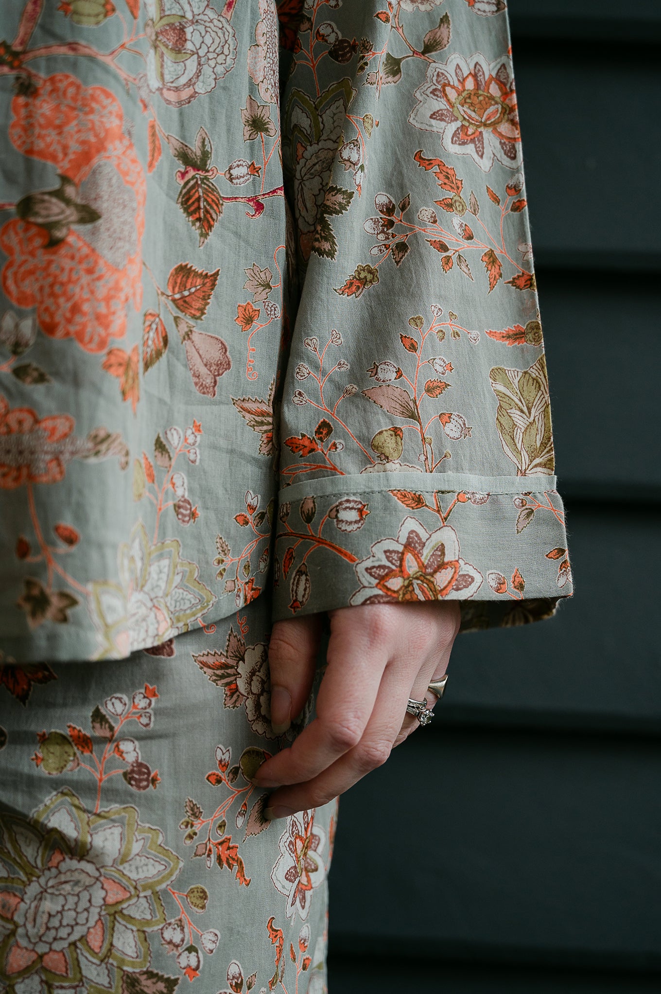Juniper Hearth cotton voile pyjamas, screen printed with floral print on sage green background.