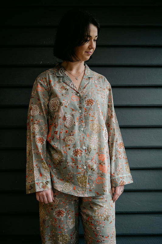 Juniper Hearth cotton voile pyjamas, screen printed with floral print on sage green background.