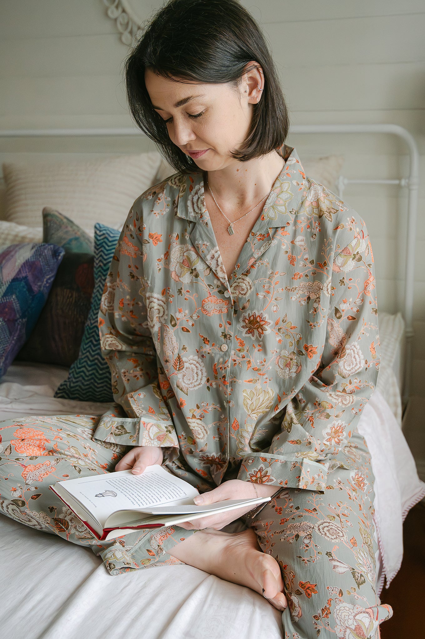 Juniper Hearth cotton voile pyjamas, screen printed with floral print on sage green background.