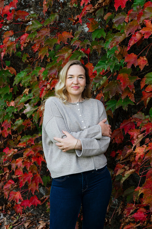 Juniper Hearth ash grey marle reversible one size cashmere cardigan, roll neck edges to neck, sleeves and hem, shell buttons, can be worn as a cardigan or reversed as a sweater.