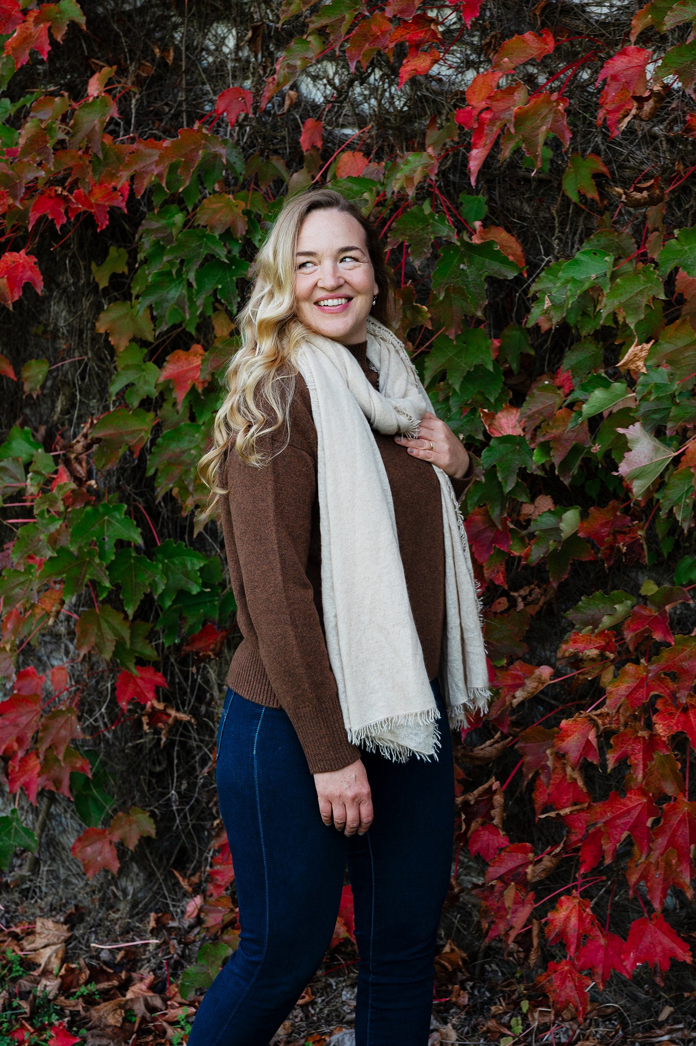 Juniper Hearth high neck turtleneck cashmere sweater in umber brown, light cashmere fringed scarf in vanilla.