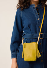 Load image into Gallery viewer, Nancybird Form pouch leather phone bag in mustard yellow with beads and tassel detail.