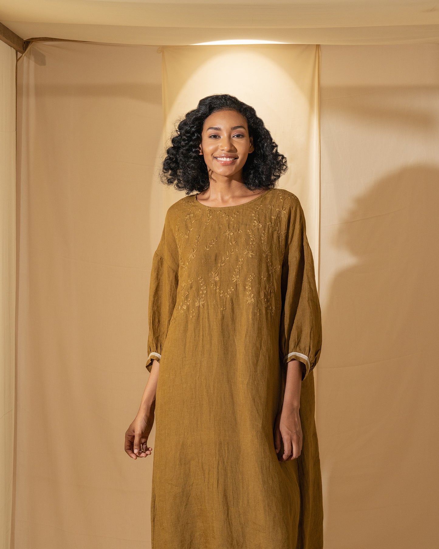 DVE Viha dress in handloom hand embroidered linen, A-line shape in mustard.