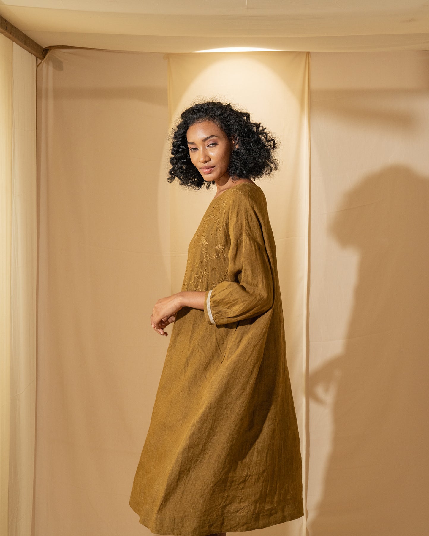 DVE Viha dress in handloom hand embroidered linen, A-line shape in mustard.