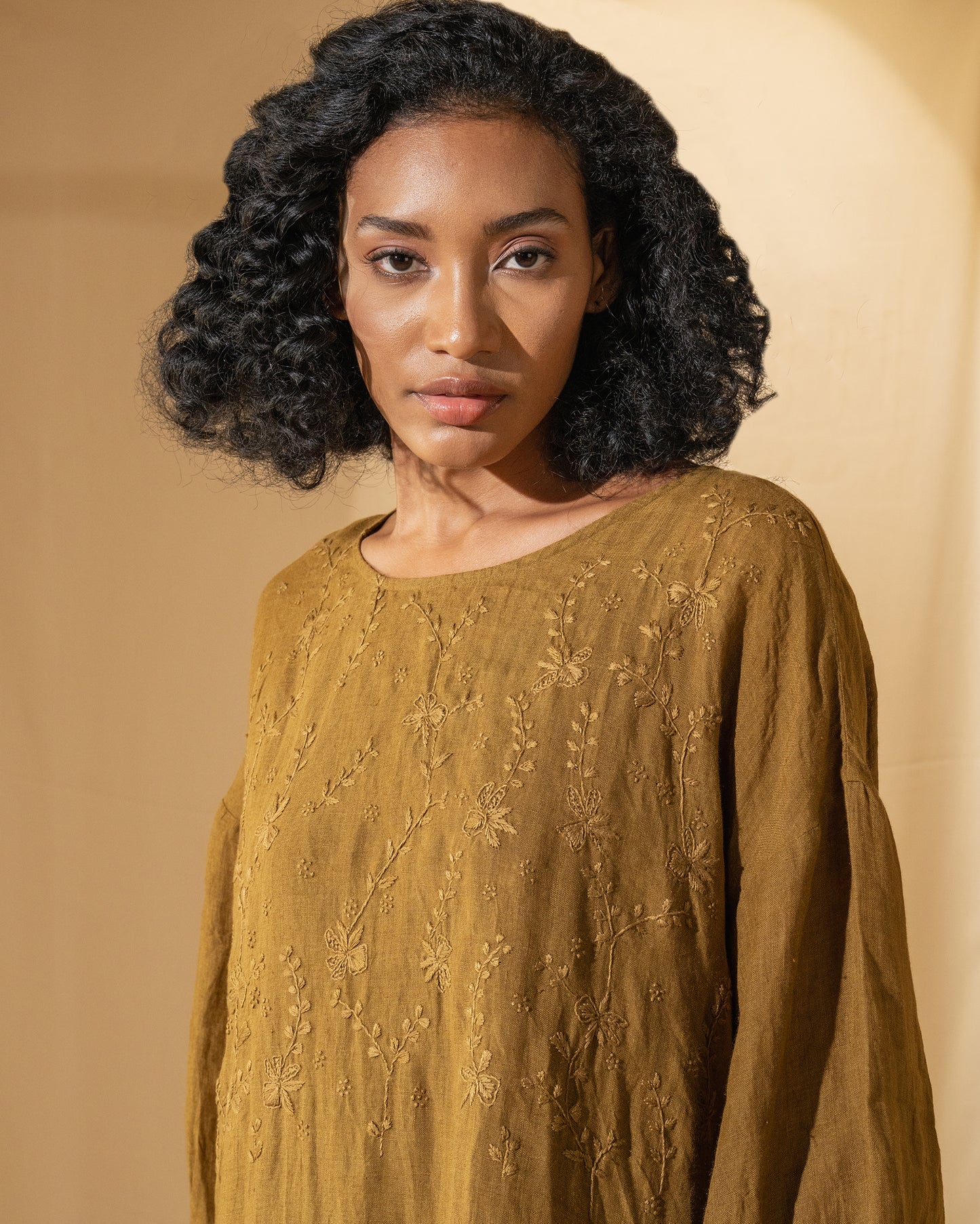 DVE Viha dress in handloom hand embroidered linen, A-line shape in mustard.