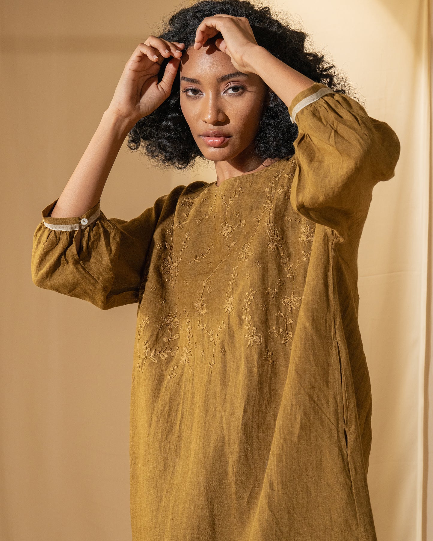 DVE Viha dress in handloom hand embroidered linen, A-line shape in mustard.