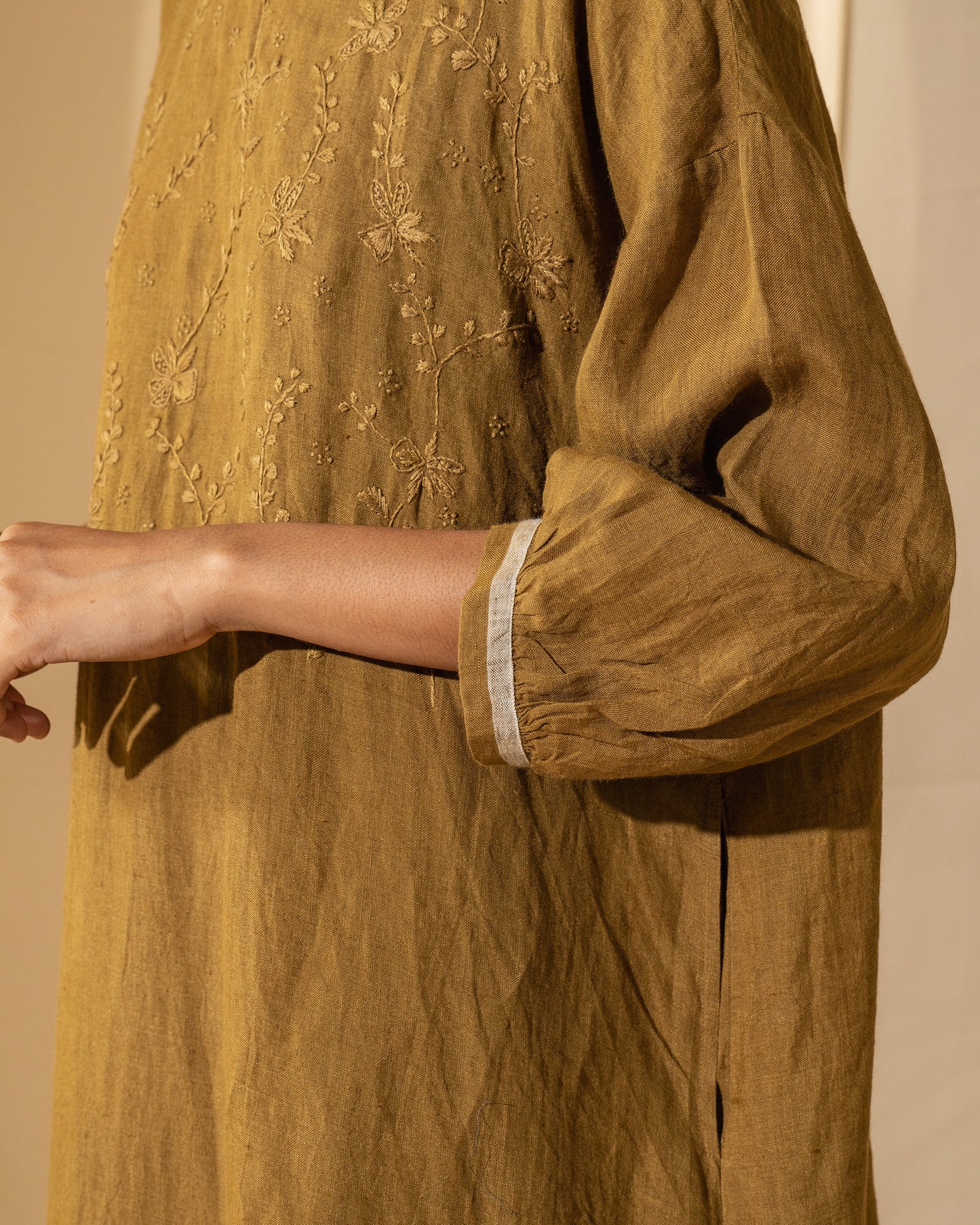 DVE Viha dress in handloom hand embroidered linen, A-line shape in mustard.