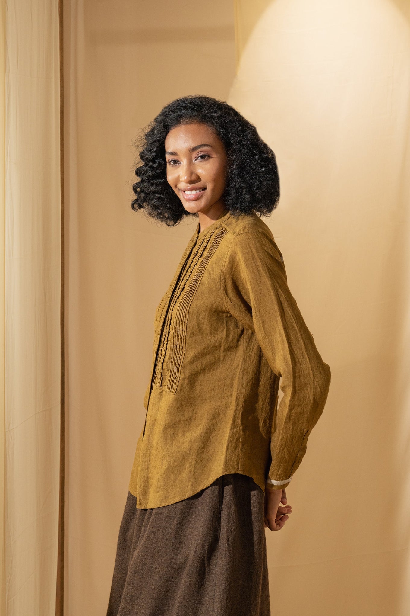 DVE Gargi blouse with pintucked and ruched details in mustard handloom linen.