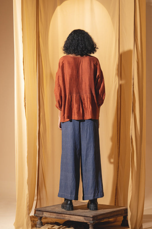 Dve Collection Anisha pintuck blouse in rust silk.