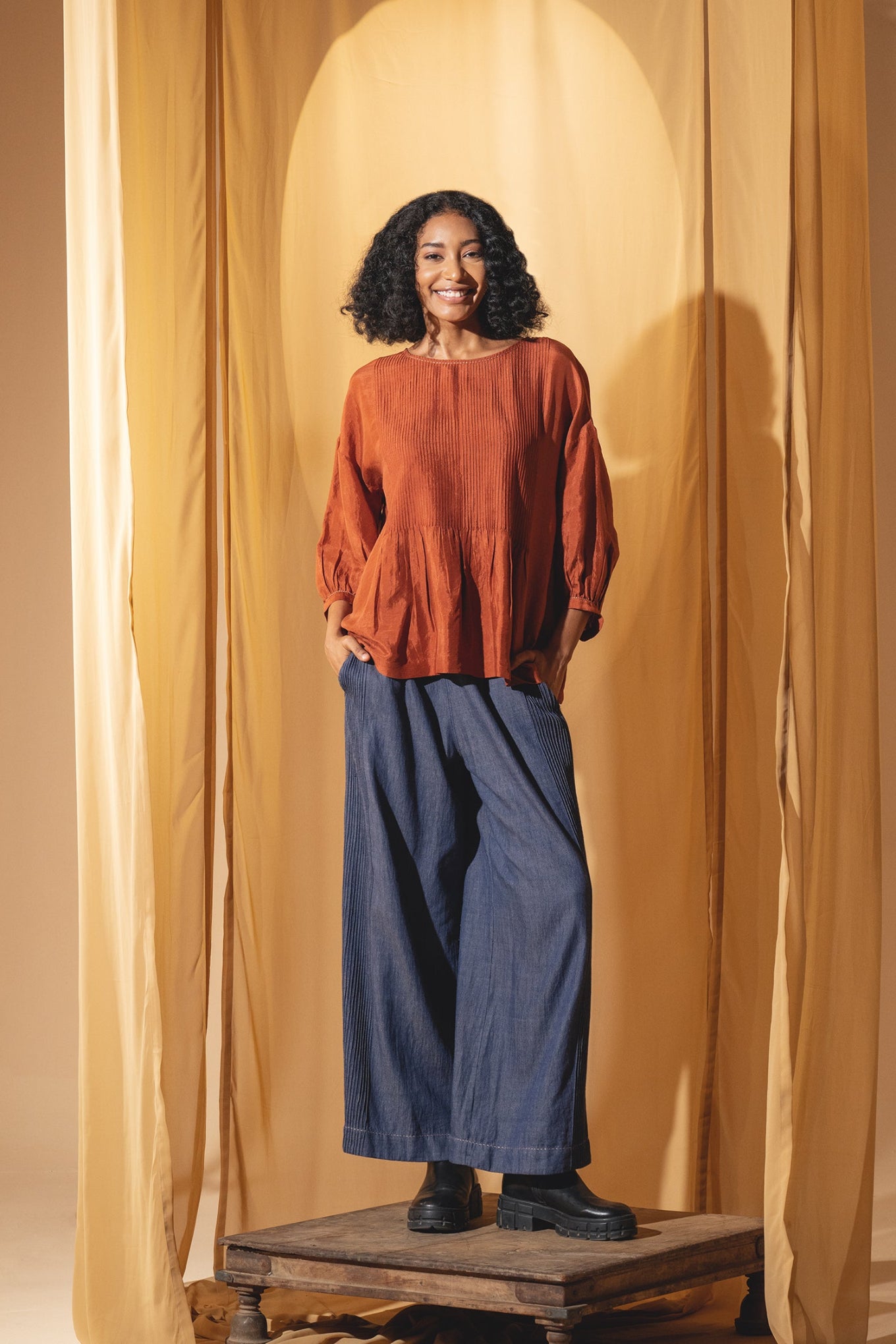 Dve Collection Anisha pintuck blouse in rust silk.
