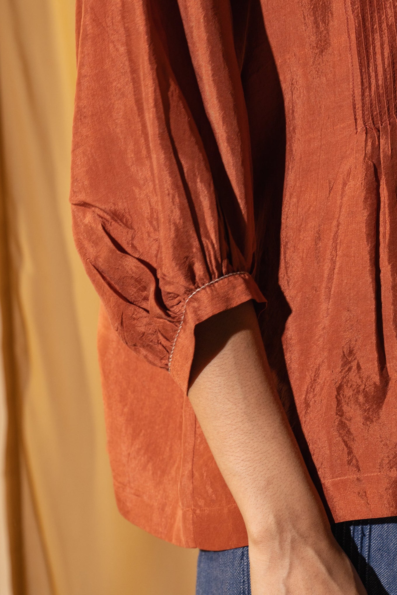 Dve Collection Anisha pintuck blouse in rust silk.