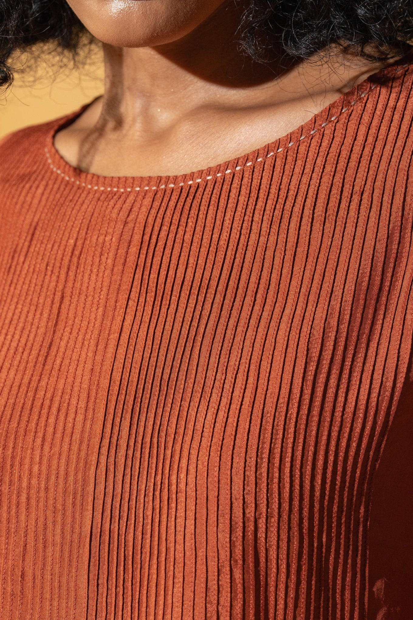 Dve Collection Anisha pintuck blouse in rust silk.