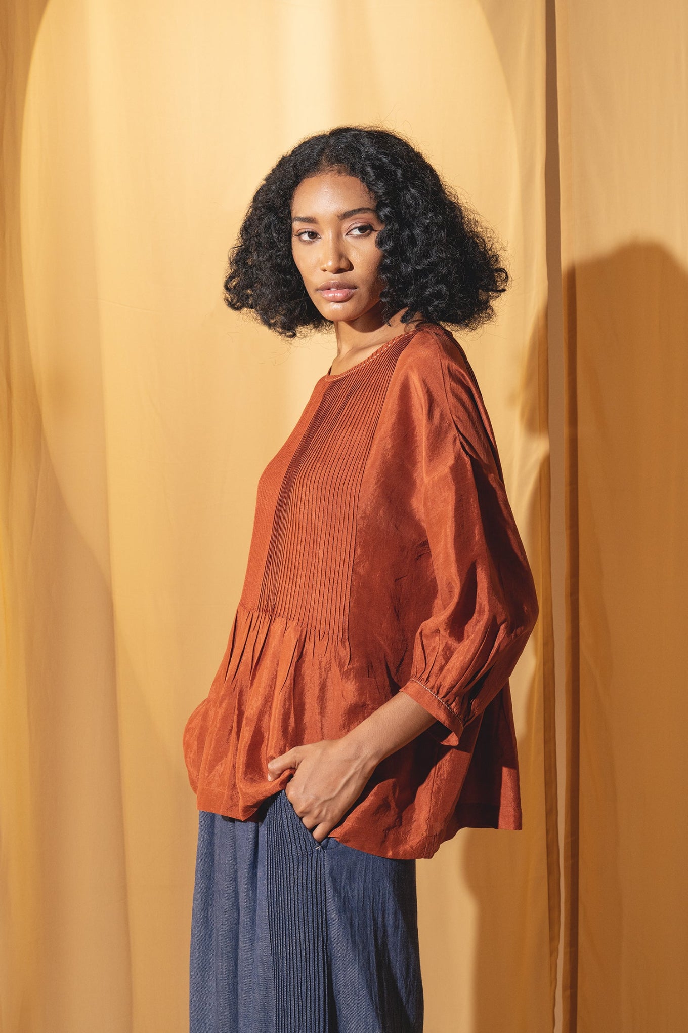 Dve Collection Anisha pintuck blouse in rust silk.