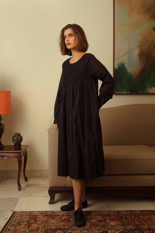 DVE Collection Tanisi long sleeved smocked dress in black paper cotton.