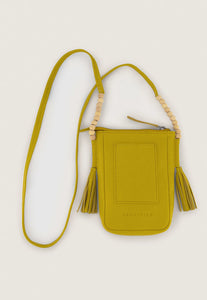 Nancybird Form pouch leather phone bag in mustard yellow with beads and tassel detail.
