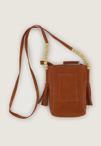 Nancybird Form pouch leather phone bag in pumpkin tan with beads and tassel detail.